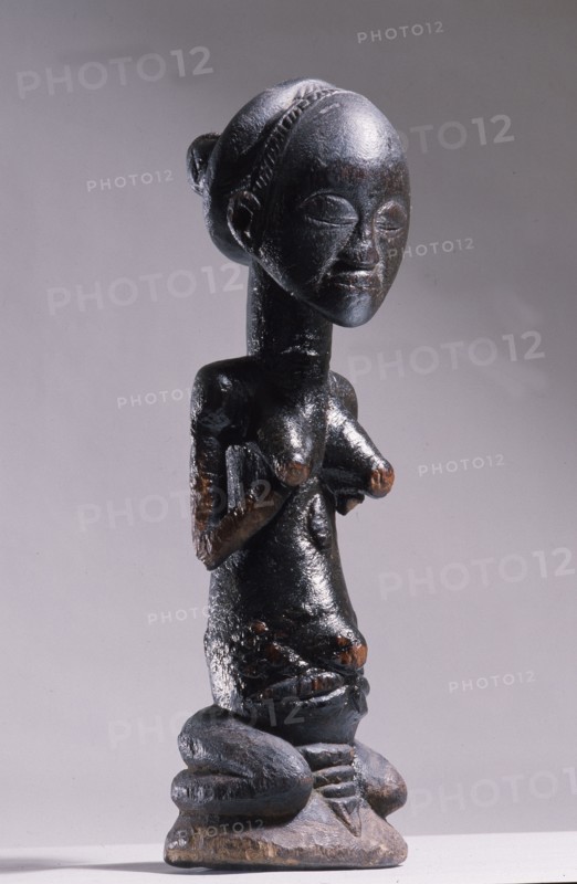 Wooden figure of Luba woman, served as a prestige possesion of a chief or king, illustrating the social and political importance of royal women in Luba society