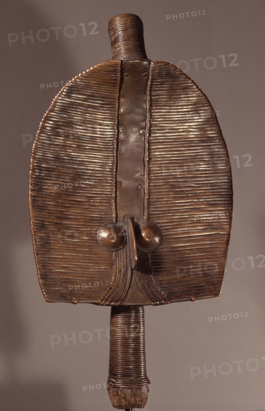 Guardian figures, called boho na bwete attached to bark boxes or bundles containing bones and other relics of clan or village ancestors, serving to protect them and as a focus for prayers and sacrifices