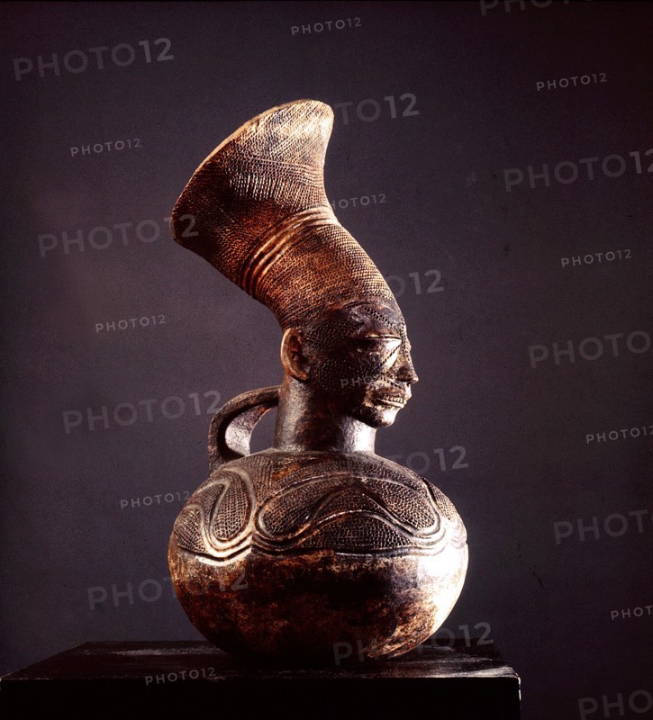 Jar depicting the womens headdress and the lengthened skull achieved by binding the heads of babies among the Mangbetu
