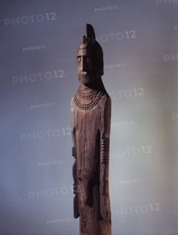 Wooden memorial statue used as a grave marker