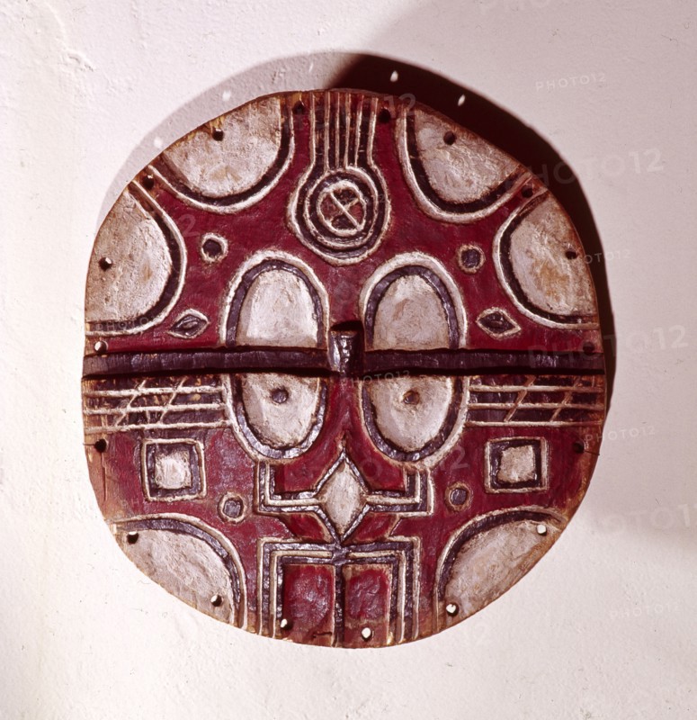 Circular mask used among the Tsaye in rituals of the Kidumu association, expressing social values through the abstract symbols taught to initiates