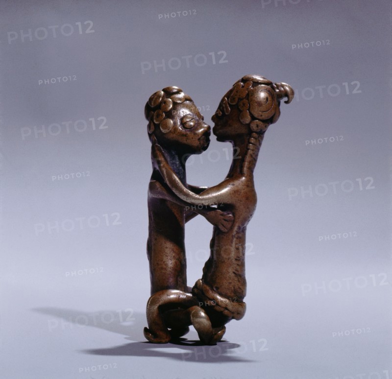 A gold weight representing a man and woman during sexual intercourse