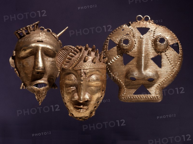 Gold pendants in the form of a stylized heads