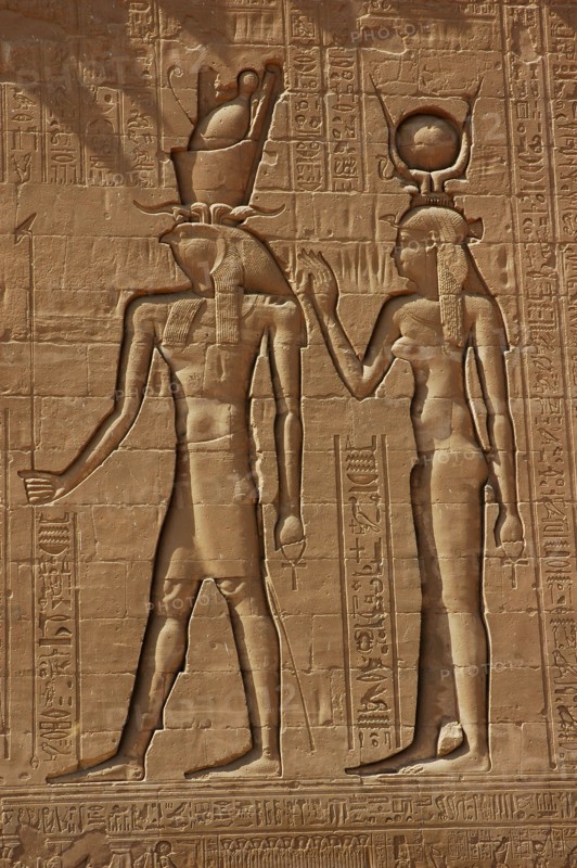Reliefs on the outer back walls of the temple complex depicting a pharaoh and the goddess Isis