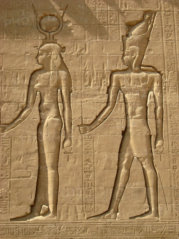 Reliefs on the outer back walls of the temple complex depicting a pharaoh and the goddess Isis