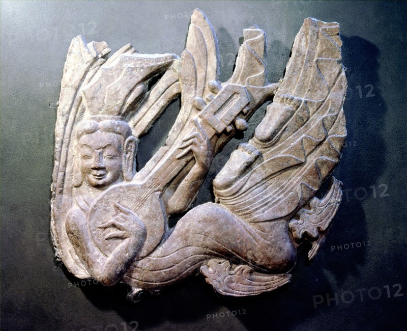 Architectural detail showing a flying apsara (celestial being) playing a musical instrument