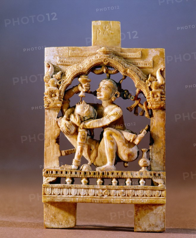 An ivory panel probably from a bed or a swing carved with an erotic scene