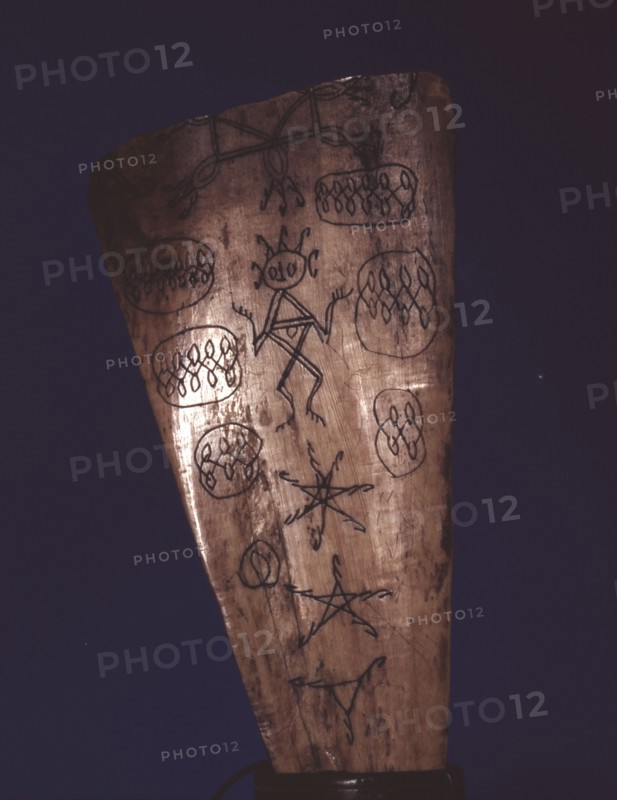 Bone amulet, inscribed by a Batak shaman with a spirit figure, pentacles, writing and other designs from their magic books