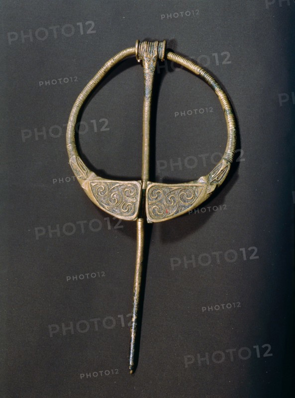 Enamelled brooch which owes its shape to Roman Britain but the flow of curves and counter curves is in the spirit of Celtic work of nearly a thousand years before