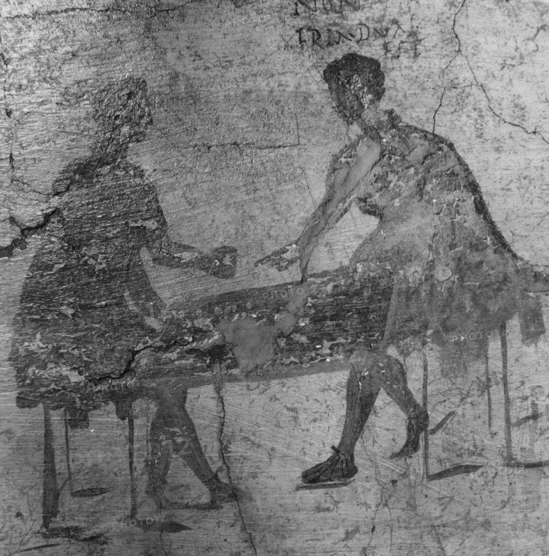 An inn sign depicting two men playing dice