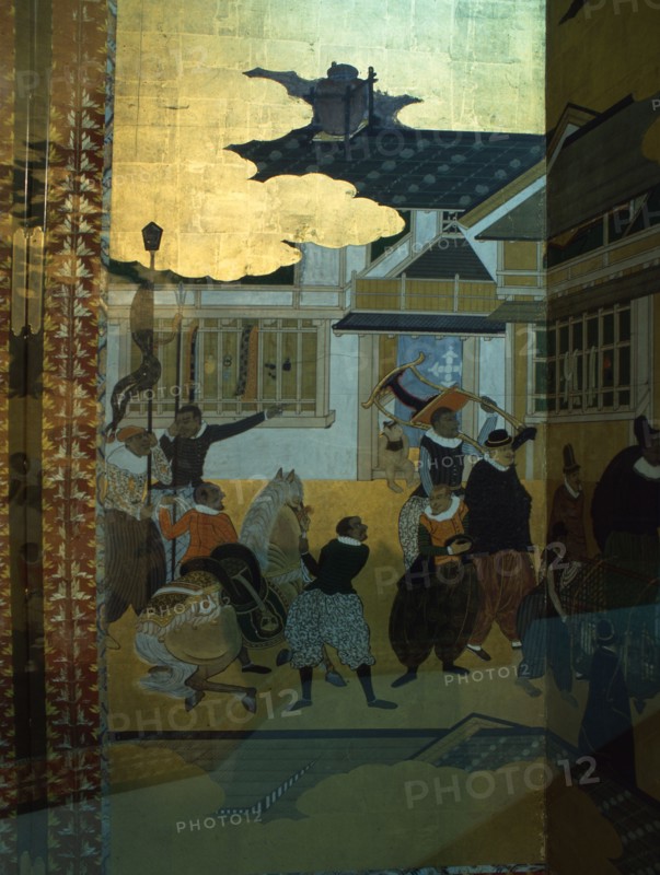 Detail from a folding namban jin or southern barbarian screen depicting a harbour scene recording the arrival of exotic looking Portuguese merchants in Japan
