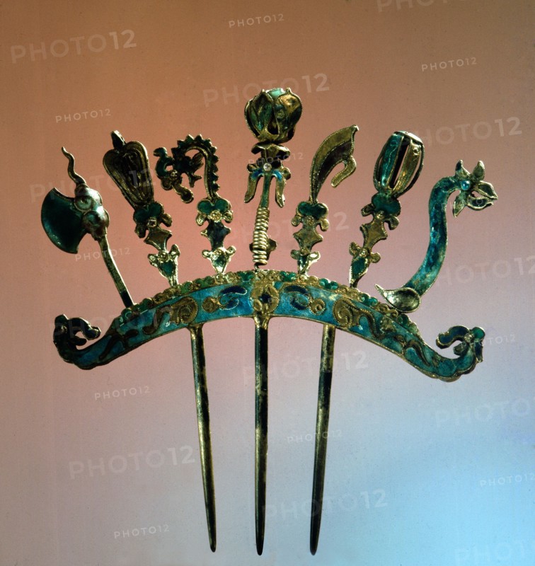 An enamelled silver comb ornamented with sacred ceremonial weapons of ancient China