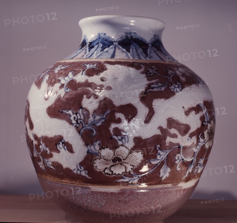 A pot with an underglaze painting of Taoist symbols, the dragon and the peony