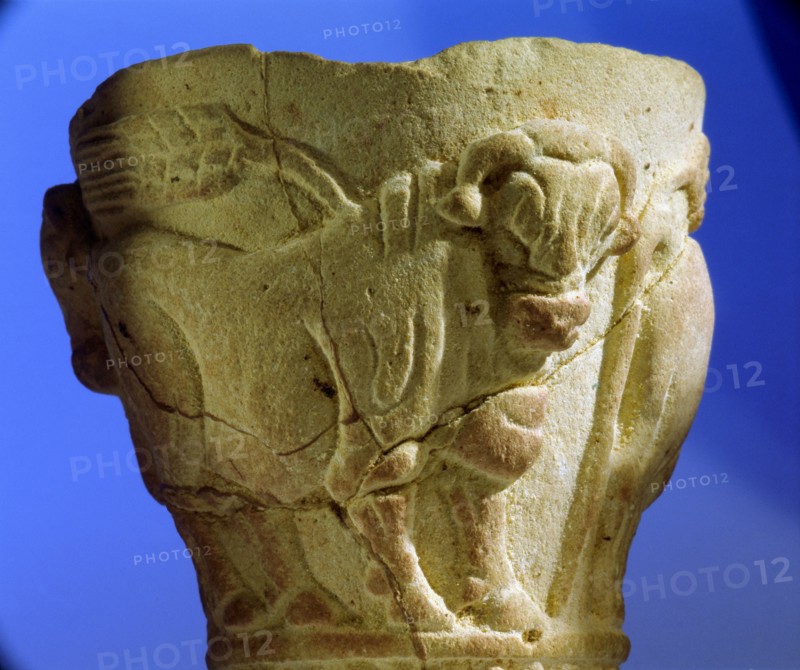A stone cup decorated with bulls and ears of corn in raised relief