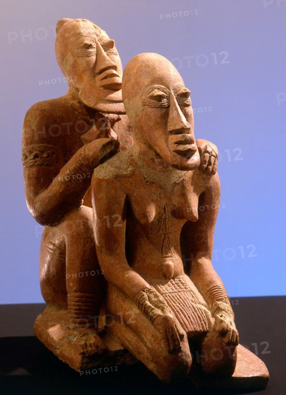 Terracotta figures of a man seated behind a woman