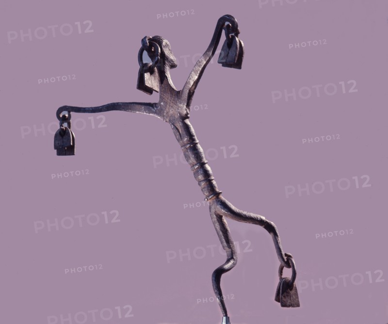 An altar iron in the form of a stylized dancing figure