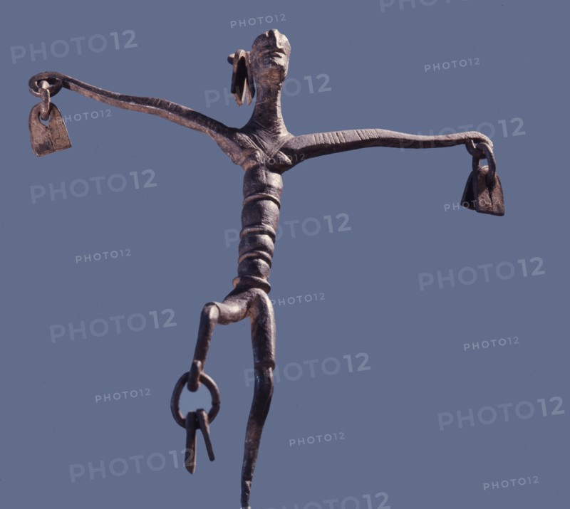 An altar iron in the form of a stylized dancing figure