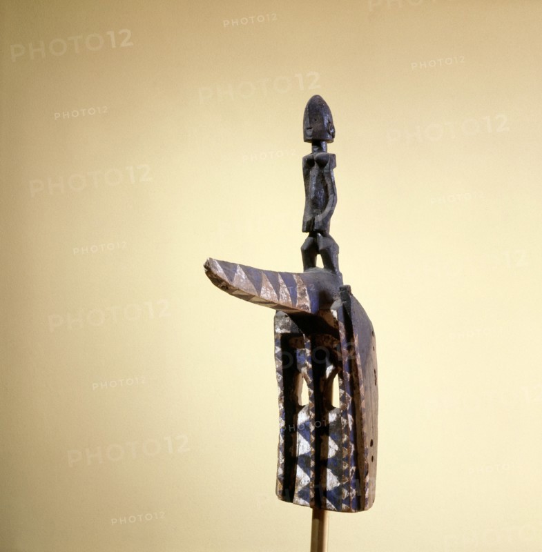 A hornbill mask topped by a female figure, this is one of over seventy different types of mask to dance at the great drama commemorative celebrations of important Dogon elders