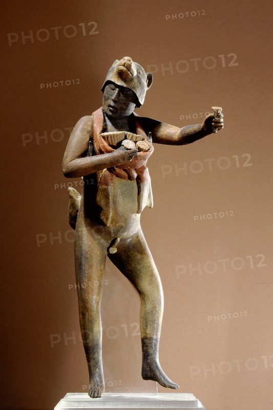 Nude male figure of a dancer holding a bunch of flowers in each hand