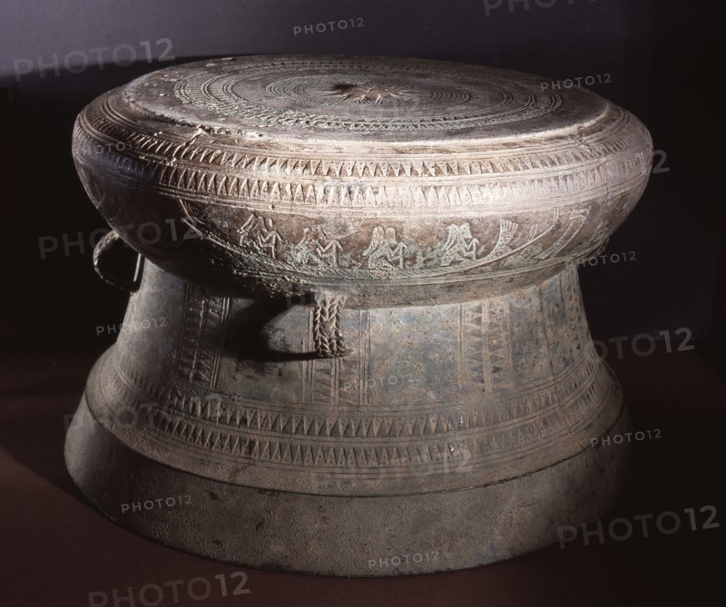 Detail of decoration on a Dong Son drum, depicting figures with feathered headdresses in a boat