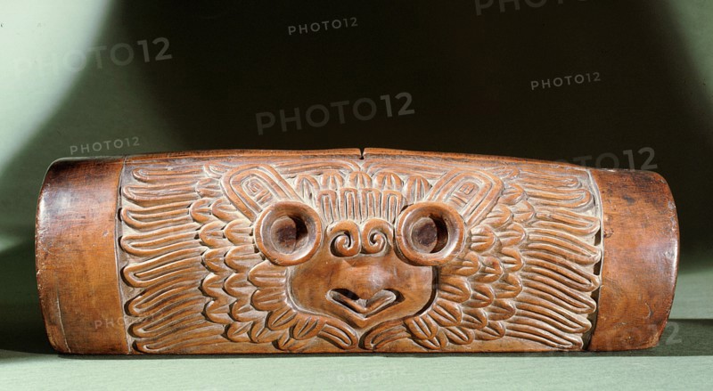 A teponaztli or two toned drum with a horned owl carved on the side