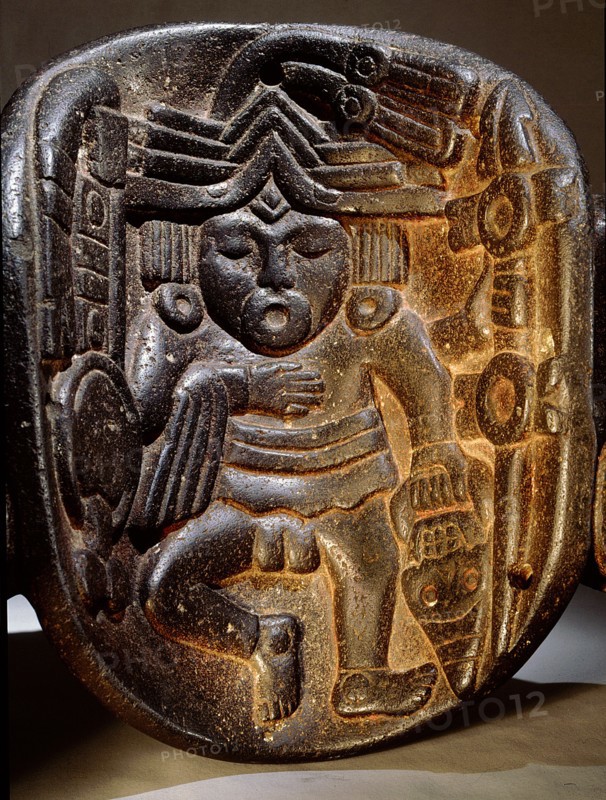Stone mask of Xipe Totec, the Flayed Lord, dressed in the skin of a sacrificial victim