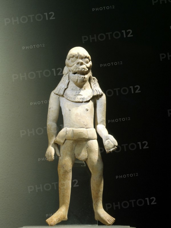 Standing ball player wearing a skull headdress