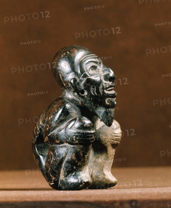 Olmec figure of a crouching man