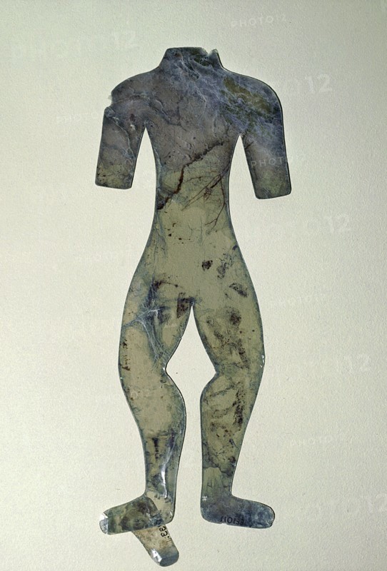 Silhouette of a mutilated human figure cut from a thin sheet of mica