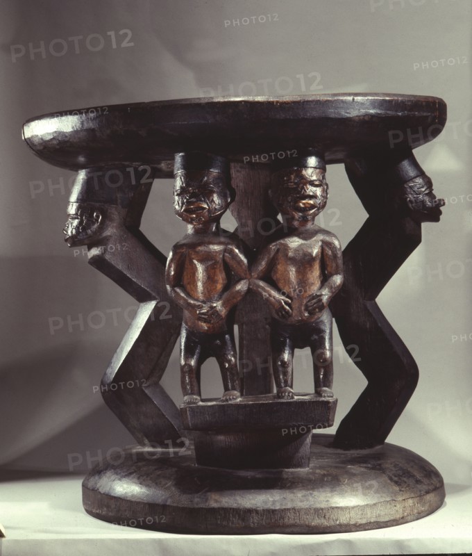 Stool supported by human figures, probably carved for an important elder or chief