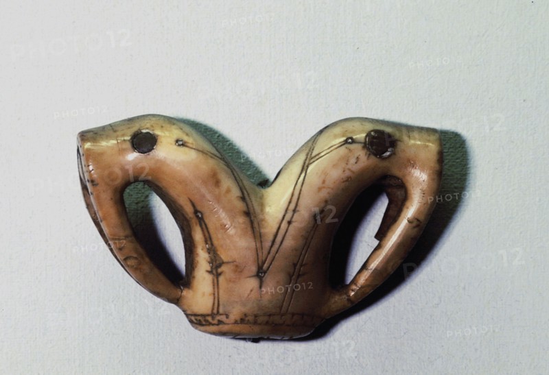 Ivory ornament depicting two walrus heads