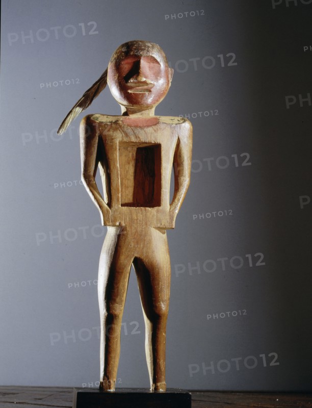 Carved wood figure with rectangular opening in the chest, used by the Midewiwin secret society