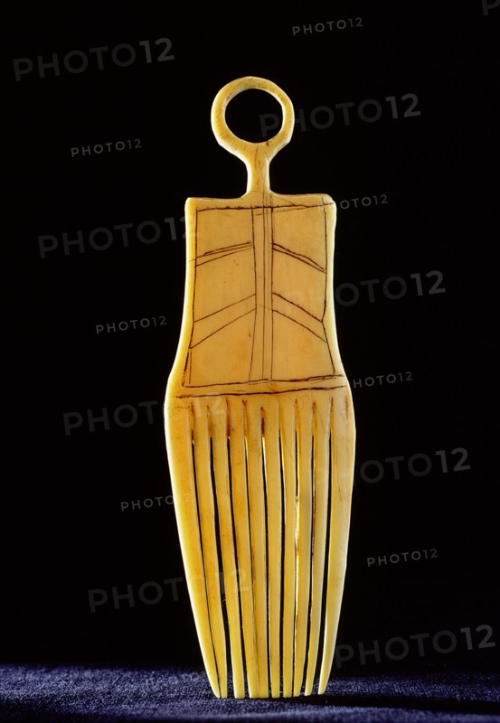 Ivory comb in shape of a stylised human figure