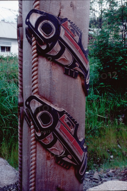 Detail of totem pole showing carving of two salmon