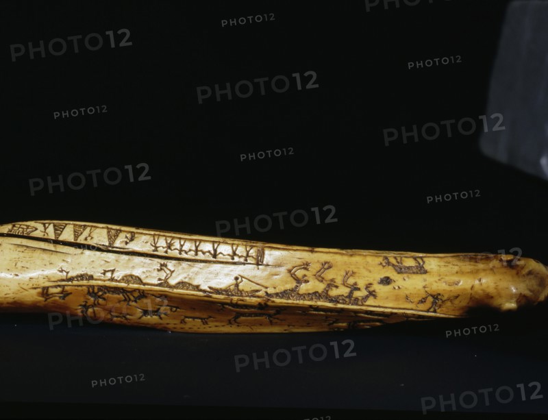 Incised bow drill handle illust rating a number of scenes