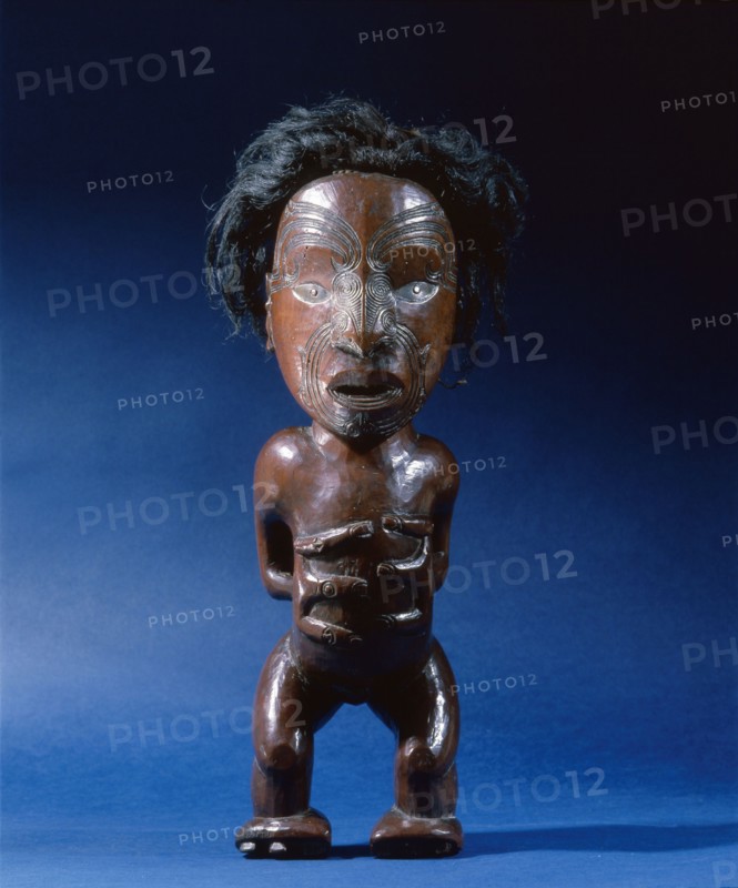 Carved wooden human figure with inlaid metal eyes and human hair