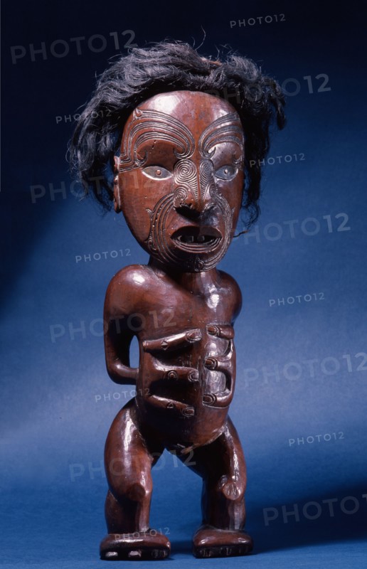 Carved wooden human figure with inlaid metal eyes and human hair