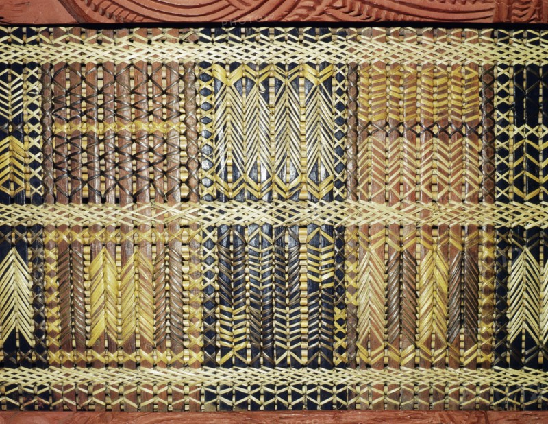 Reed latticework panels woven by women alternated with the carved wooden ancestor figures along the side wall of meeting houses
