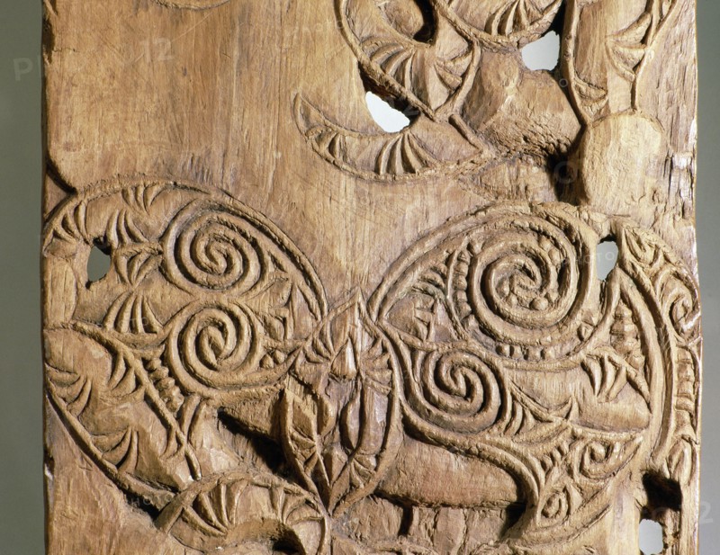 Carved in unusually low relief, this end post, epa, from a Taranaki storehouse depicts the interaction of ancestral figures and manaia, profile figures representing the supernatural world