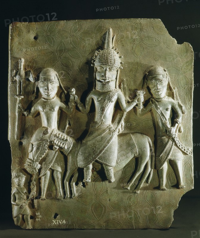 Benin brass plaque from the palace, depicting an Oba on horseback supported by two retainers
