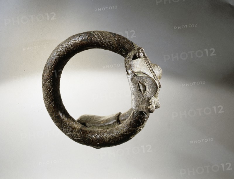 A Benin armlet terminating in a crocodile head