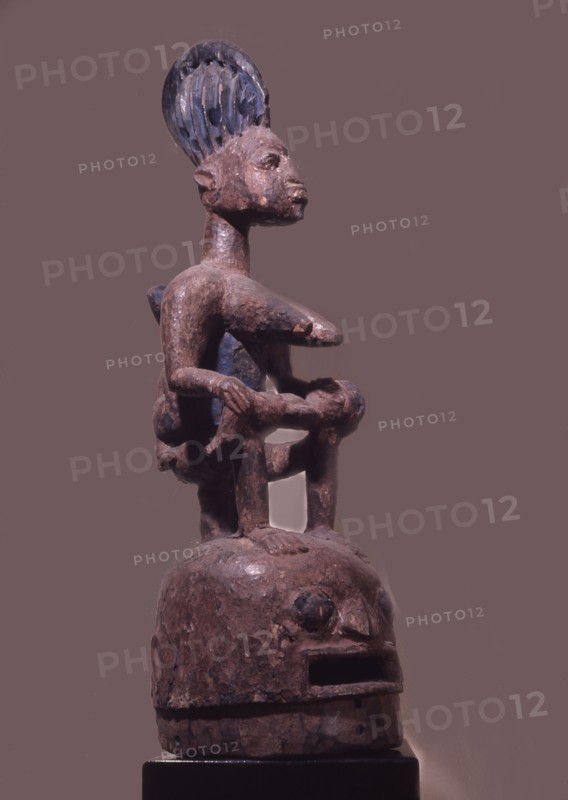Epa helmet mask with typical mother and child motif, used in a masquerade honouring lineage ancestors in the northern Ekiti Yoruba area