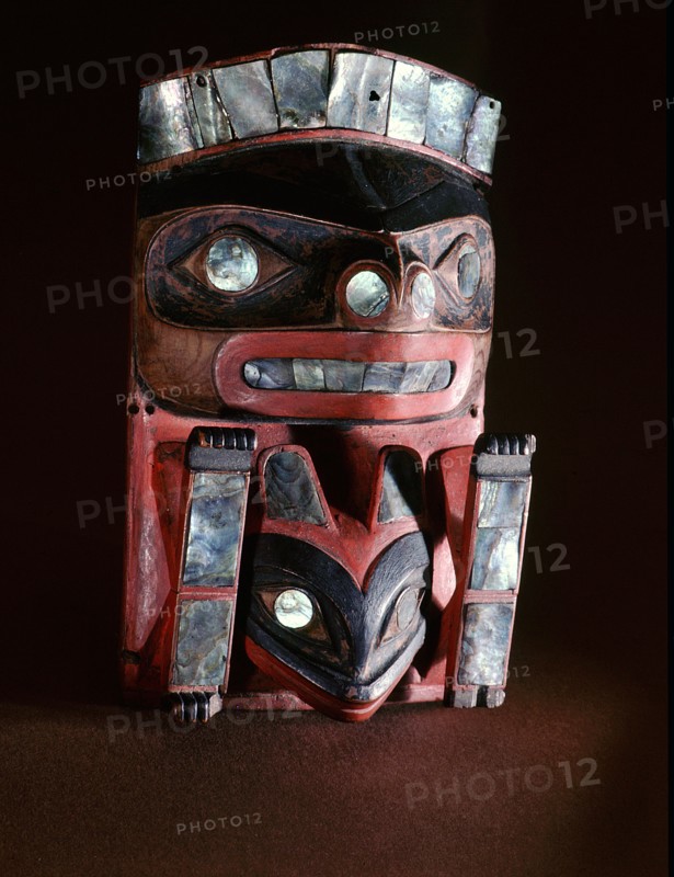 Frontlet plaque carved and painted to represent a beaver with a frog between his front paws