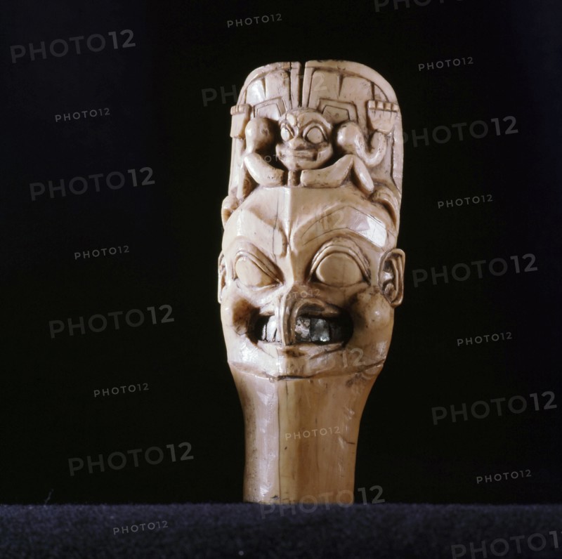 Probably a shamans charm showing the common Northwest Coast feature of applying symbols of animals to essentially human faces