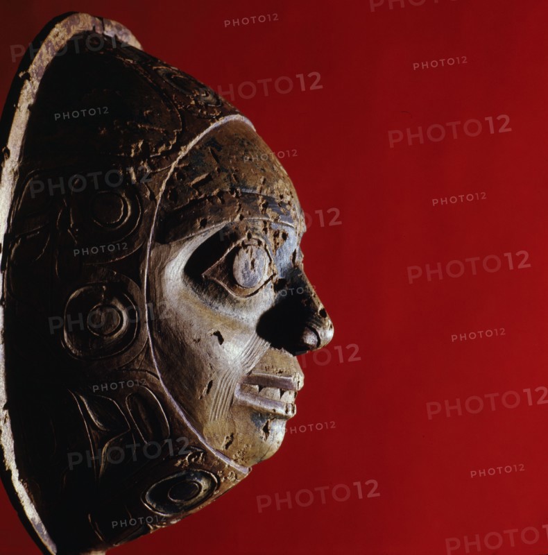 Shamans rattle in the form of a face with a border carved in low relief
