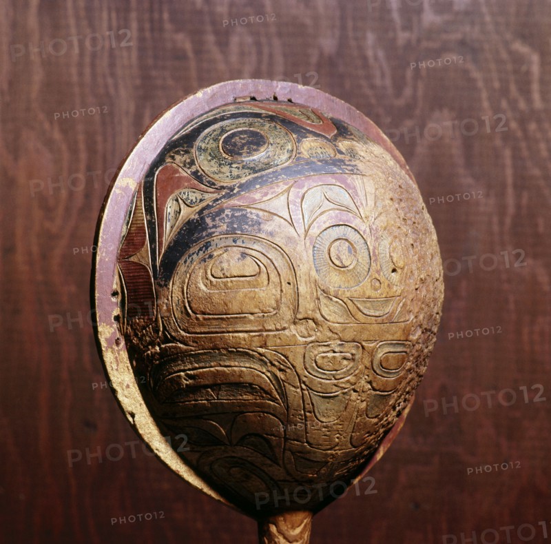 Shamans rattle painted and carved in low relief