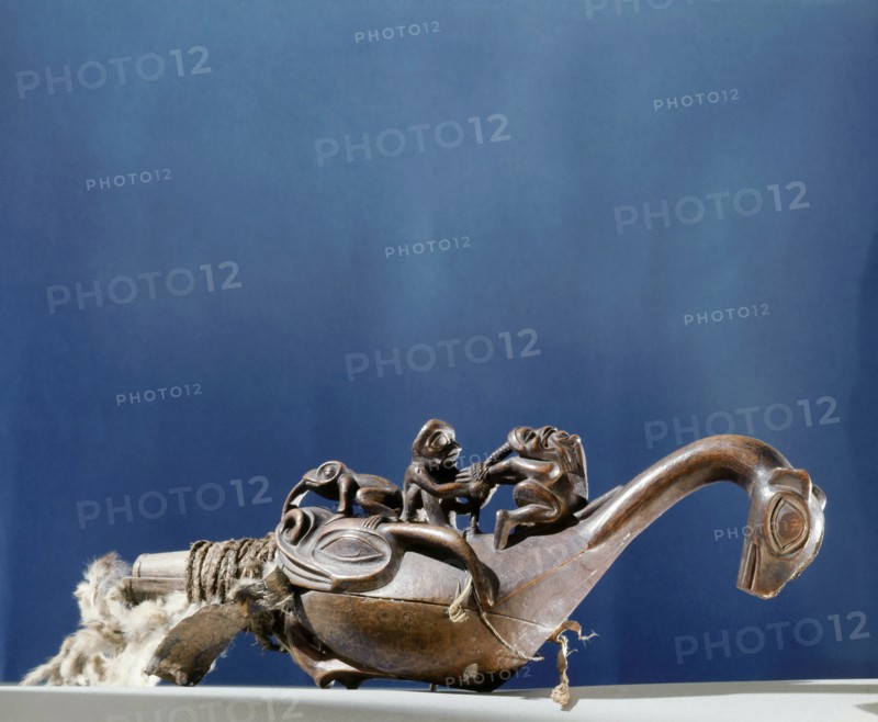 Shamans rattle in the form of a bird or sea monster with a shaman torturing a witch on its back