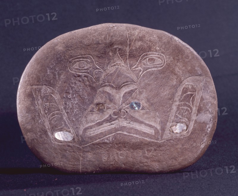An incised drawing of a dogfish on a section of bone with inlaid abalone shell