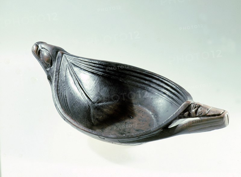Feast bowl with a seals head at one end and a totemic human face at the other