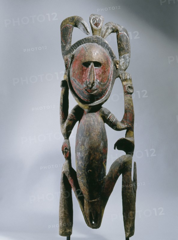 Squatting female clan spirit figure with two hornbills, from a Maprik region mens society meeting house